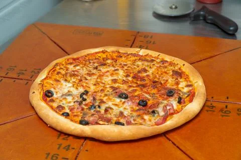 Pizza on a cutting board. Stock Photos