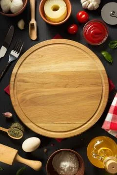 Pizza cutting board at table Stock Photos