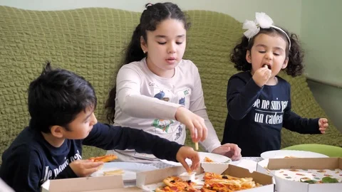 Pizza delivery. boy and two girls eating pizza and French fries Stock Footage 125691803