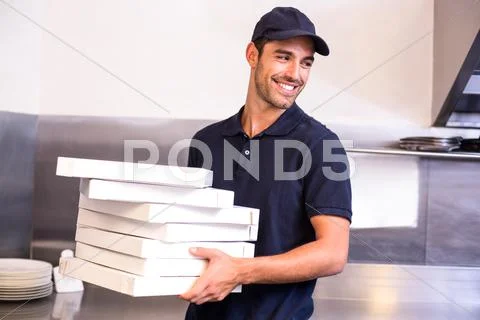 Pizza delivery man carrying boxes Stock Photos