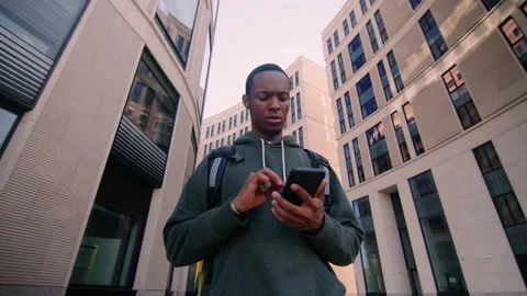 A pizza delivery man walks between the buildings of business centers Stock Footage 217364155