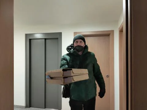 Pizza delivery man with the wrong mask on Stock Photos