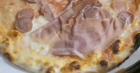 A pizza for dinner with mozzarella, raw ham and sliced wurstel. Stock Footage 143110713