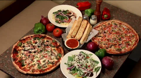 Pizza dinner with salad &amp; breadsticks, static shot Stock Footage 24632275