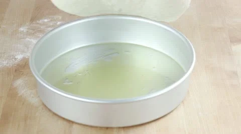 Pizza dough being placed in a deep pizza dish Video stock 24672531