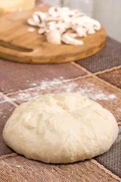 Pizza dough sitting on the table Stock Photos