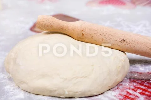 Pizza dough on the table with rolling pin Stock Photos