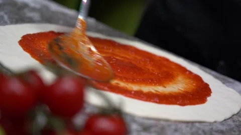 Pizza dough with tomato sauce on table Video stock 135311575