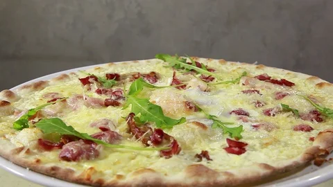 Pizza with egg, sausage, arugula and cheese. Italian cuisine. Side view. Revo Stock Footage