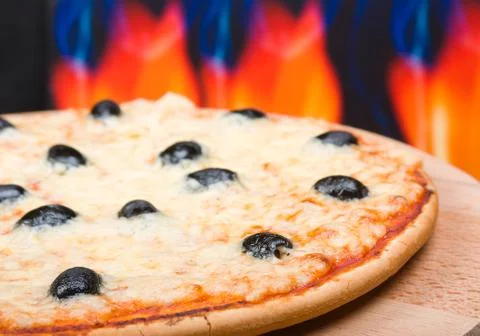 Pizza  with fire on background. Stock Photos