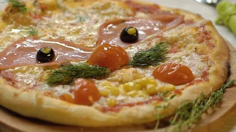 Pizza in the form of a funny face with a mustache from the leaves of dill, eyes Video stock 75054514