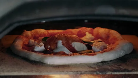 Pizza getting baked in the oven Video stock 132848623