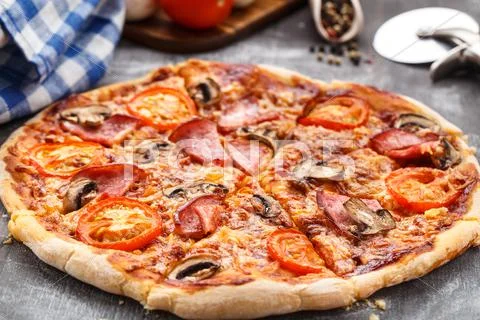 Pizza with ham and mushrooms Stock Photos