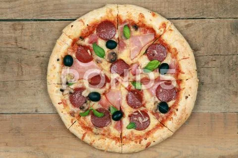 Pizza with ham and pepperoni Stock Photos