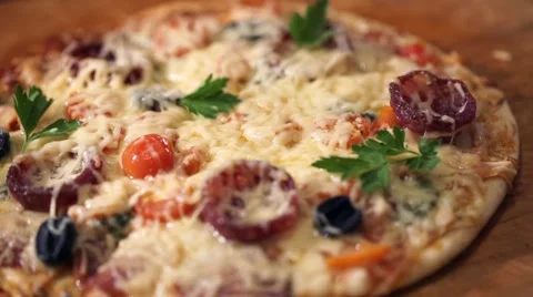 Pizza with ham, pepper, tomato and olives Stock Footage 60840318