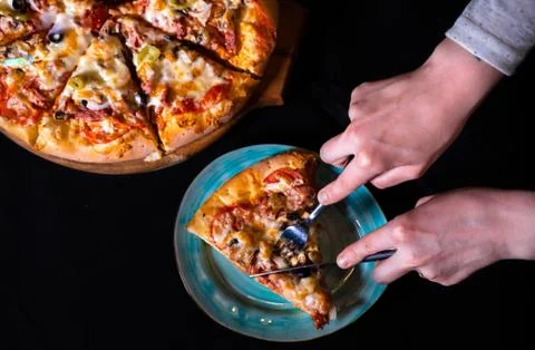 Pizza hand cut Stock Photos