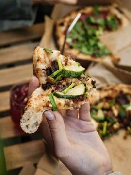 Pizza in hand on the street Stock Photos