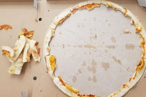 Pizza leftovers in a portable box, the process of eating pizza. Stock Photos