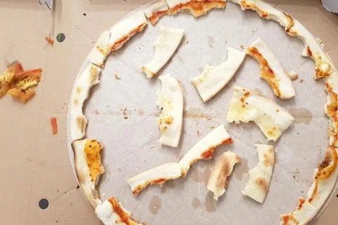 Pizza leftovers in a portable box, the process of eating pizza. Stock Photos
