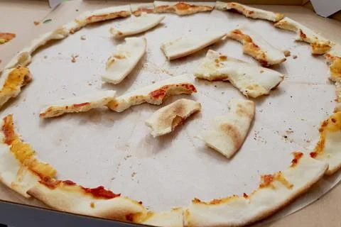 Pizza leftovers in a portable box, the process of eating pizza. Stock Photos