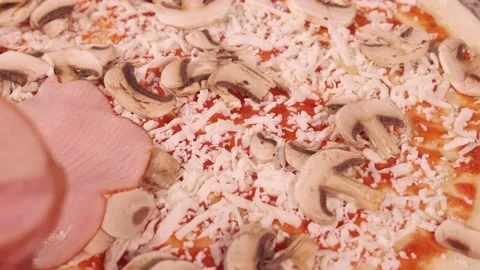 Pizza maker adds sliced bacon to pizza Video stock 158403532