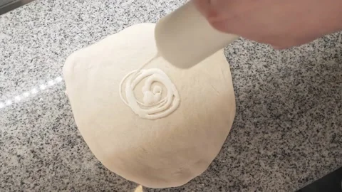 Pizza maker pours low calorie mayonnaise on rolled dough Stock Footage 132474071
