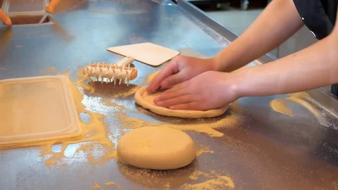 Pizza maker prepare dough in the restaurant for making pizza - stretching dough 動画素材 118526005