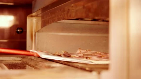 Pizza maker puts pizza in the oven Stock Footage 158403659