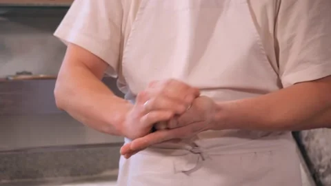 Pizza maker rolls dough piece making ball form in kitchen Stock Footage 132126101