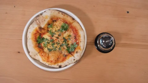 Pizza maker takes fragrant baked dish from kitchen table Stock Footage 132474033