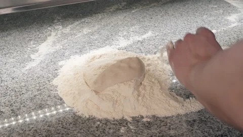 Pizza maker wraps raw dough in flour rolling on table Stock Footage 133359765