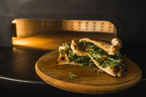 Pizza making process, baked pizza in front of an oven, restaurant kitchen Stock Photos