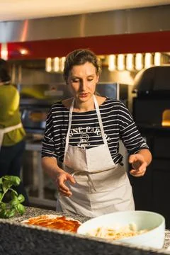Pizza making process in the restaurant kitchen, italian cuisine Stock Photos