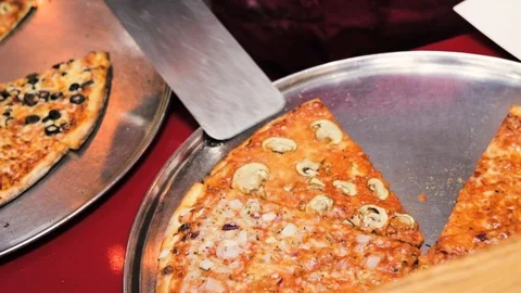 Pizza man serves a slice of pizza Stock Footage