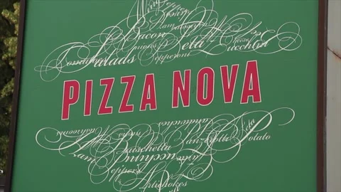 Pizza nova square sign, red writing on green background with fancy art Stock Footage 246611865