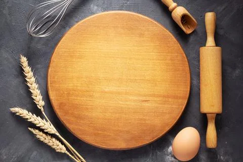 Pizza or bread cutting board with bakery ingredients for homemade baking on t Stock Photos