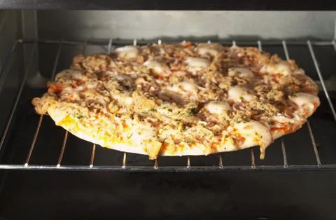 Pizza in oven Stock Photos