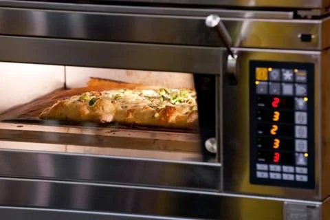 Pizza in oven Stock Photos