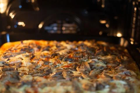 Pizza in the oven Stock Photos