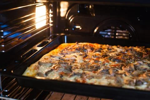 Pizza in the oven Stock Photos