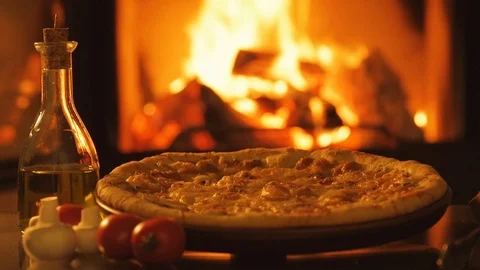 Pizza over fireplace background. Stock Footage 82543024
