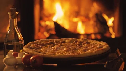 Pizza over fireplace background. Stock Footage 82543080
