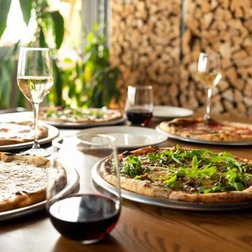 Pizza party. Assorted five different pizzas on wooden restaurant table with Stock Photos