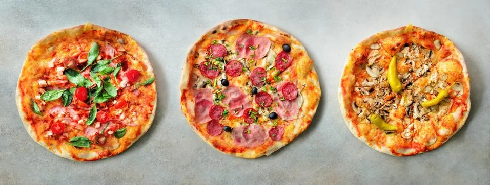 Pizza pattern. Three pieces set on grey concrete background. Top view, copyspace Фото