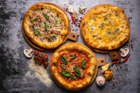 Pizza pattern. Three pieces set on grey concrete background. Top view, copysp Stock Photos