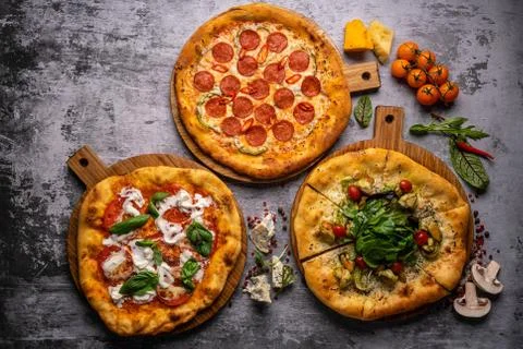 Pizza pattern. Three pieces set on grey concrete background. Top view, copysp Stock Photos