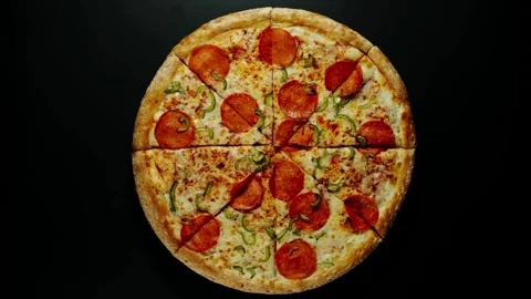 Pizza peperoni top view, several people take apart pieces of pizza from the Stock-Footage 336586697