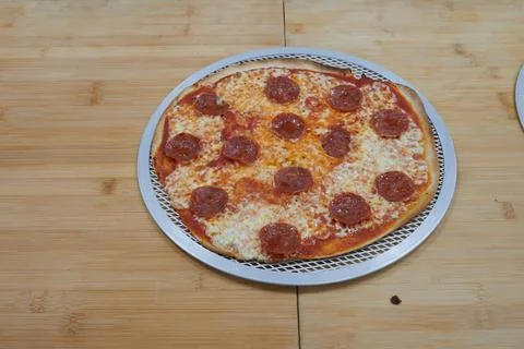 A pizza with pepperoni on it Stock Photos