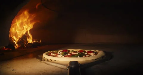 The pizza is placed in a stone oven Stock Footage 231629292