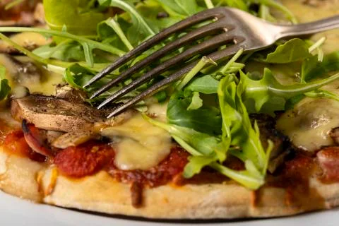 Pizza on a plate with arugula Stock Photos